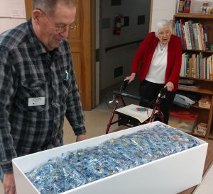 John Noer looking over 40,000 pieces for his next puzzle
