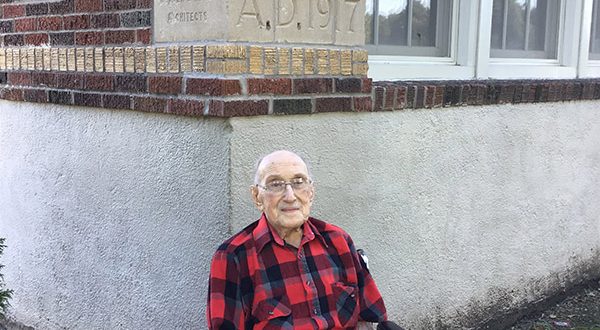 harold tindall posing in front of davis elementary school at 104