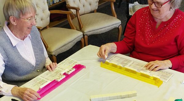 Residents Joan Baker and Rey Evans playing Mahjong