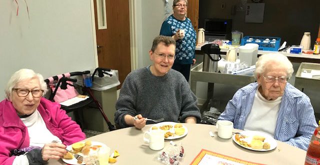 Shown enjoying Chinese New Year treats are, from left, Kathleen Heffner, Myrt Canfield, and Jennie Canfield. In the back is volunteer Carolyn Orndorff