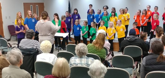 Grinnell childrens choir performs at Mayflower Community