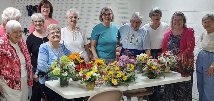 The flower arranging group, led by Betty Anne Francis, far left. Seated is Phyllis Wood. Behind Betty Anne, left to right, are Jean Libbey, M.J. Zimmerman, Heidi Roberts, Dorothy Noer, D'Ann Kelty, Karen Packard, Russ Leggett, Rey Evans, and Dot Anderson.