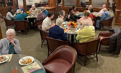Mayflower Community residents enjoy food prepared by Grinnell College's Food House and Multicultural House
