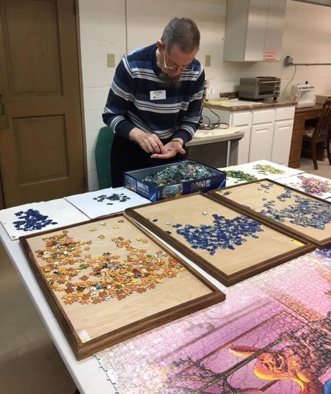 John Noer works on 40,000 piece puzzle