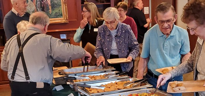 Hosts Alicemary Borthwick and Jim LaCasse lead diners down the buffet line.
