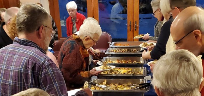 Mayflower Residents enjoying a Greek themed dinner