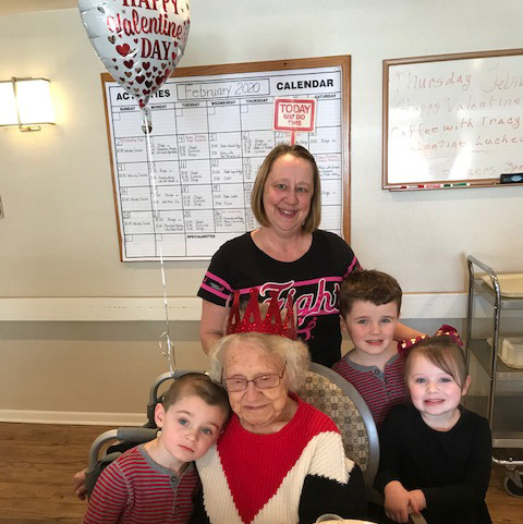 Beebe Assisted Living Queen, Frannie Robbins, is surrounded by great grandchildren and her daughter, Donna Puls, RN, Health Center nurse.