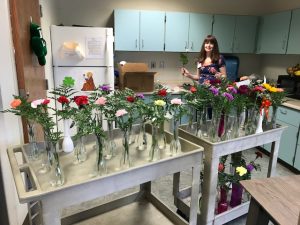 Tracy Woolford arranging flowers into vases