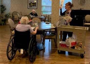 Mayflower residents, Gloria and Wilma playing Bingo as Tina Frascht calls numbers