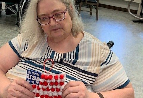 Diana Long holding the US flag craft she created.