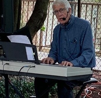 Ron Burgess plays in courtyard