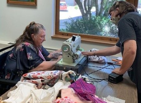 Susan Ford (right) assists Karen Stevenson who is sewing a pillow